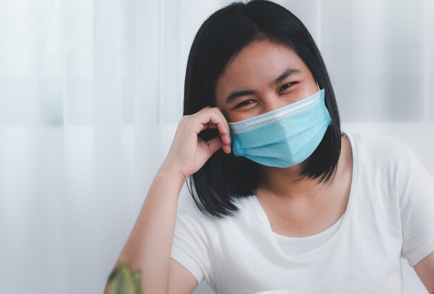 Young business woman wearing mask working from home