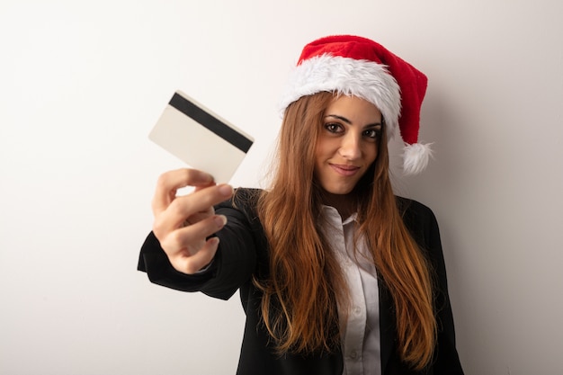 Young business woman wearing santa hat celebrating christmas day