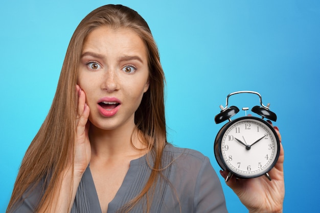 Young business woman with clock