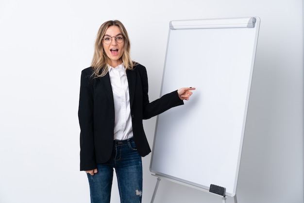 Young business woman with white board over isolated wall