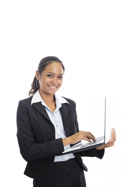 Young business woman working on her laptop while standing