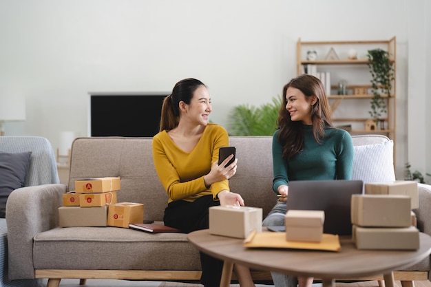 Young business woman working online ecommerce shopping at her
shop young woman seller prepare parcel box of product for deliver
to customer online selling ecommerce