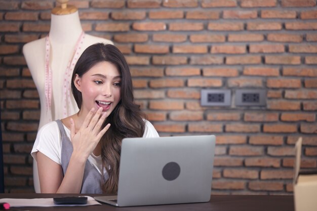 Young business woman working selling online. Surprise and shock face of asian woman success on making big sale of his online store. Online shopping