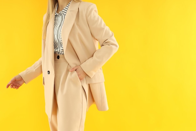 Young business woman on yellow background space for text