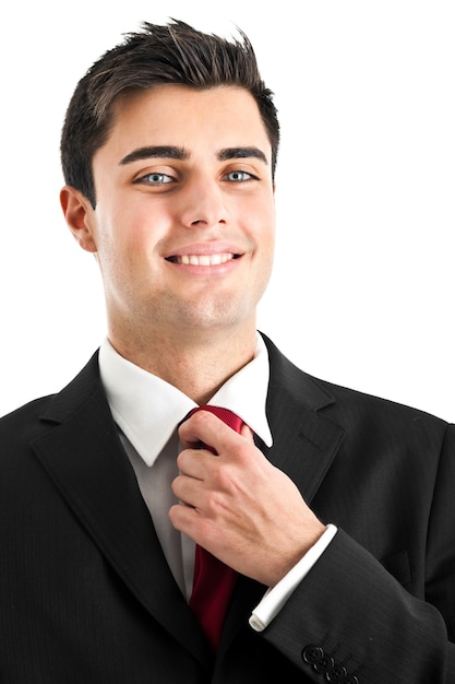 Young businessman adjusting his tie