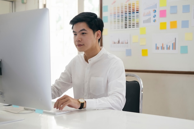 Young businessman analyze online marketing in his computer