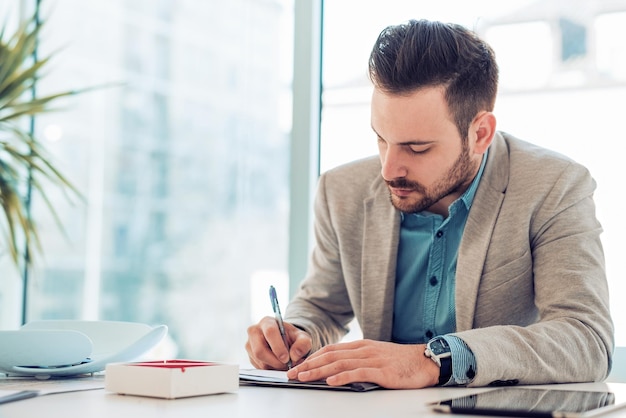 Young businessman analyzing data in office