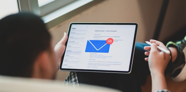 Young businessman checking his email on tablet 