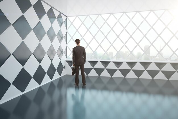 Young businessman in chessboard interior