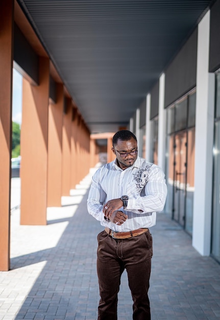 Young businessman in the city. Handsome office worker standing on the urban street.