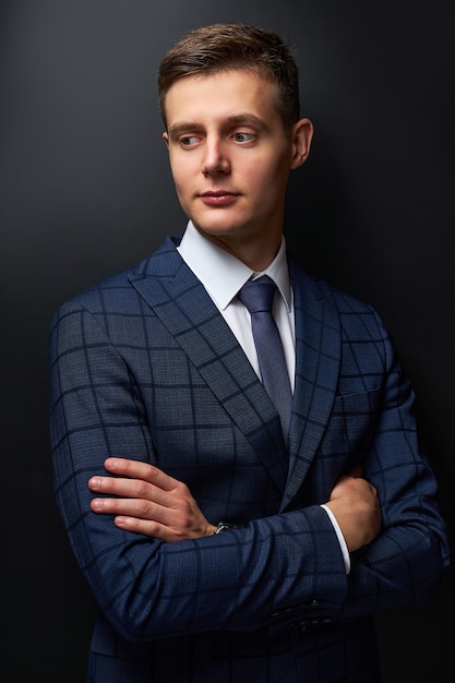 Young businessman in crossed arms