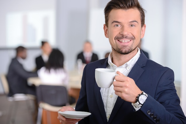 Young businessman drinking coffee.