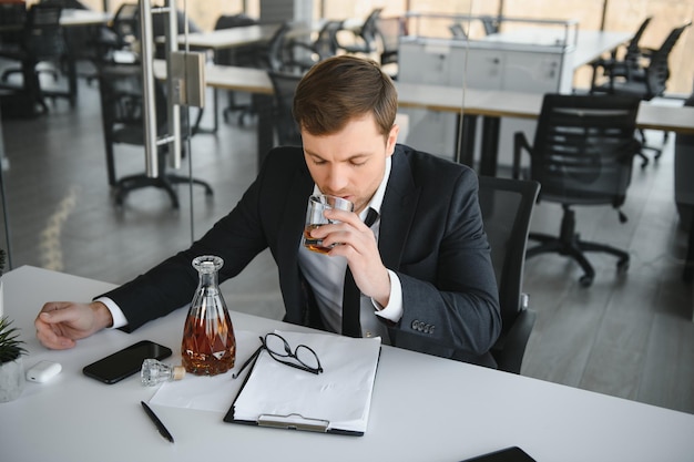 Young businessman drinking from stress