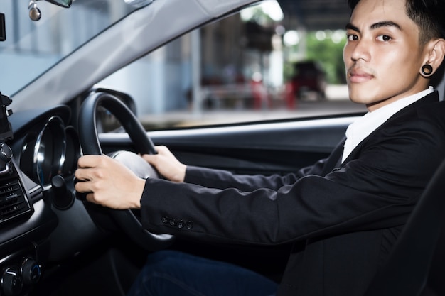 Young businessman driving a car