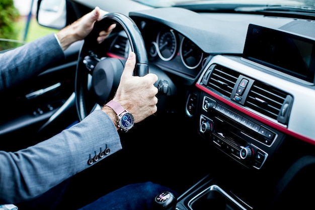 Young businessman driving car