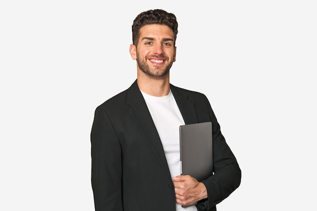 Young businessman ecstatic with joy grasping his laptop