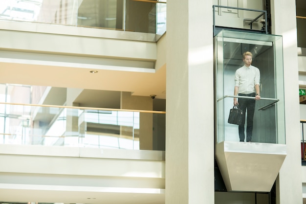 Young businessman in the elevator