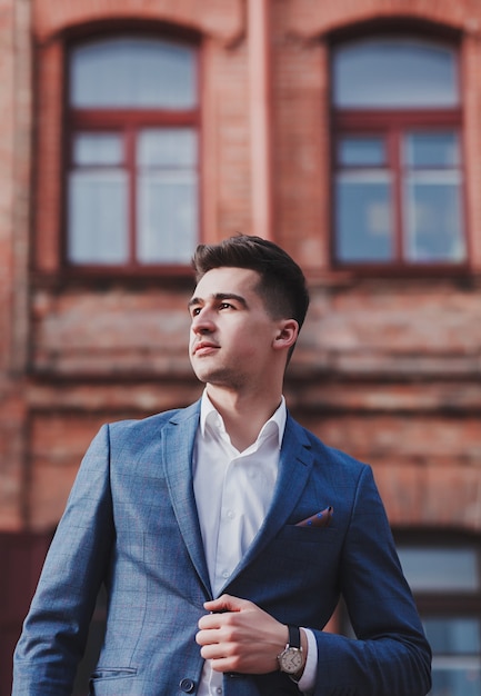 Young businessman. Fashion young man in suit standing