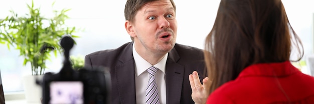 Young businessman feeling mad and expressing anger to woman colleague