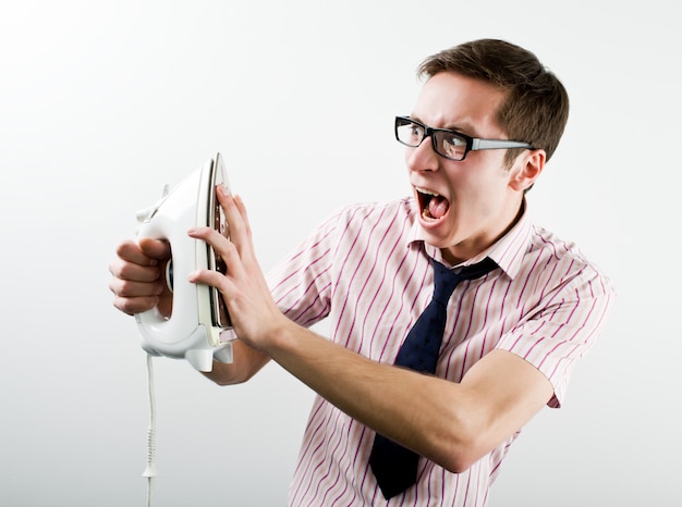 Young businessman feeling stressed touching hot iron