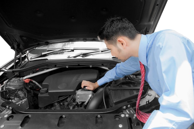 Young businessman fixing a broken car