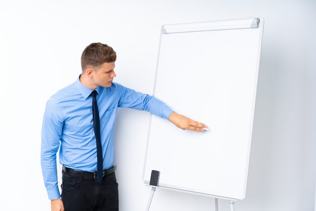 Photo young businessman giving a presentation on white board giving a presentation on white board