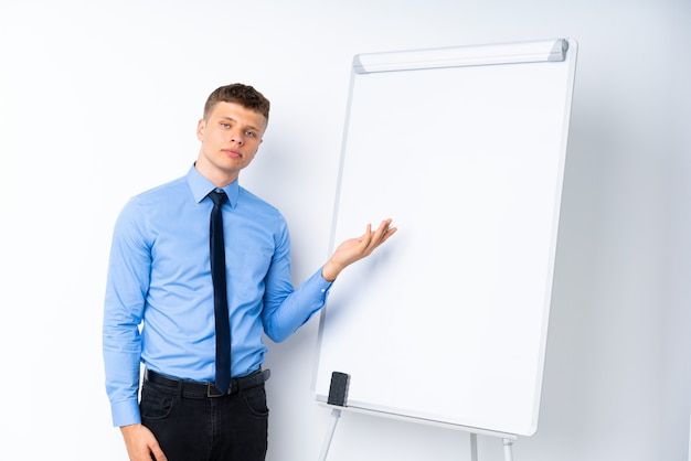 Young businessman giving a presentation on white board giving a presentation on white board