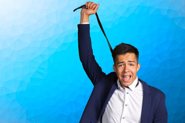 Young businessman hanging himself on tie