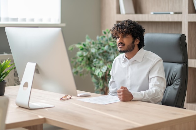 A young businessman having a video call and looking involved