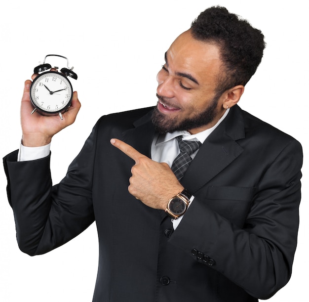 Young businessman holding alarm clock isolated on white