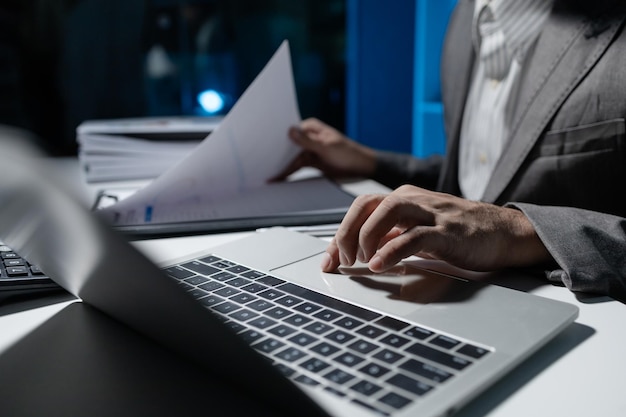 A young businessman is using a laptop to search for important information on business competitors A laptop was used to access important documents by one employee