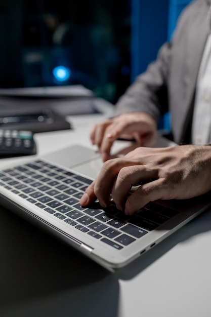 A young businessman is using a laptop to search for important information on business competitors A laptop was used to access important documents by one employee