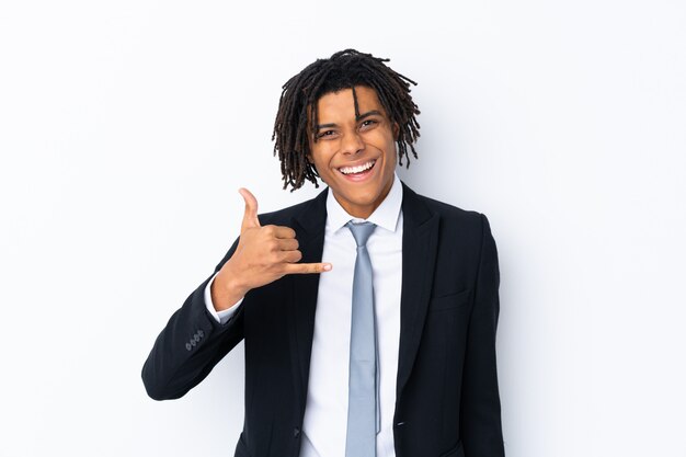 Young businessman over isolated wall