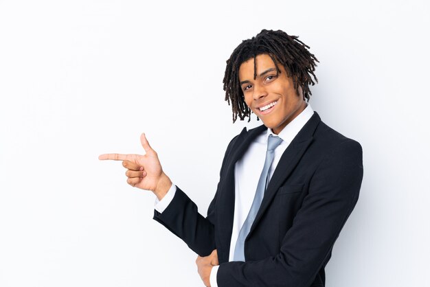 Young businessman over isolated wall