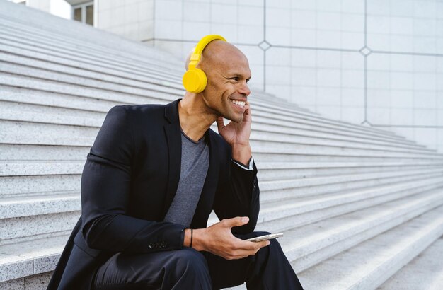 Young businessman listening to music in the morning