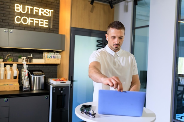 A young businessman opens his laptop to work