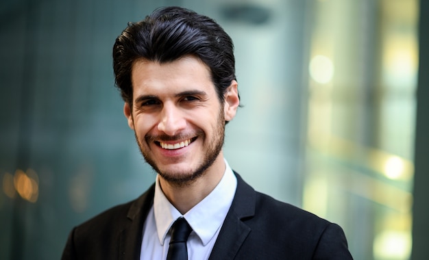 young businessman outdoor smiling confidently