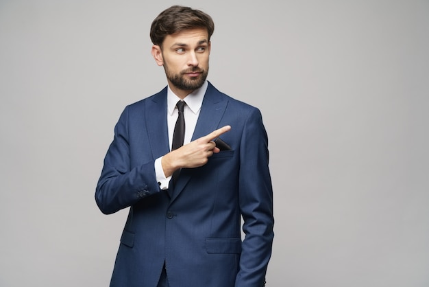 young businessman pointing on a copyspace with his finger