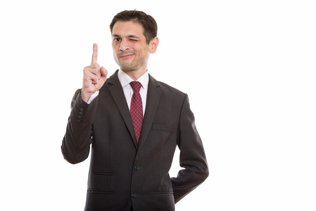 young businessman pointing finger up while winkin