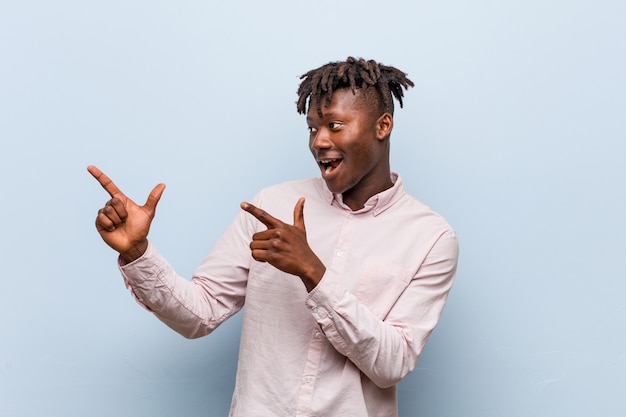 Young businessman pointing with forefingers and expressing excitement and desire