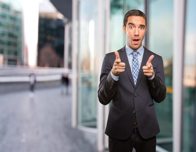 Young businessman pointing with his finger