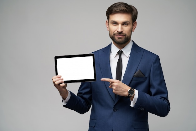 Young Businessman presenting digital tablet pc pad with blank screen