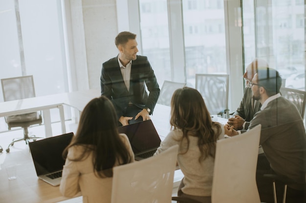 Young businessman presenting results to his coleagues in the office