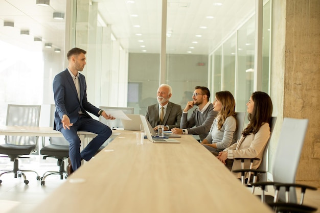 Young businessman presenting results to his coleagues in the office