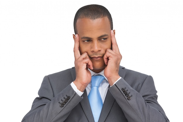 Young businessman putting his fingers on his temples