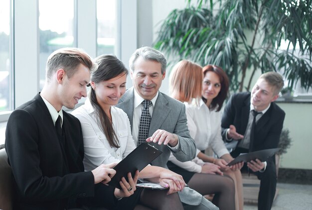 Young businessman showing a document to his colleagues.office weekdays