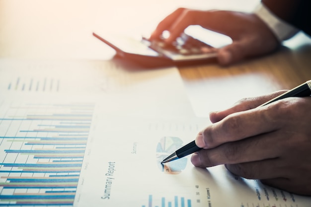 The young businessman showing graphs by pen