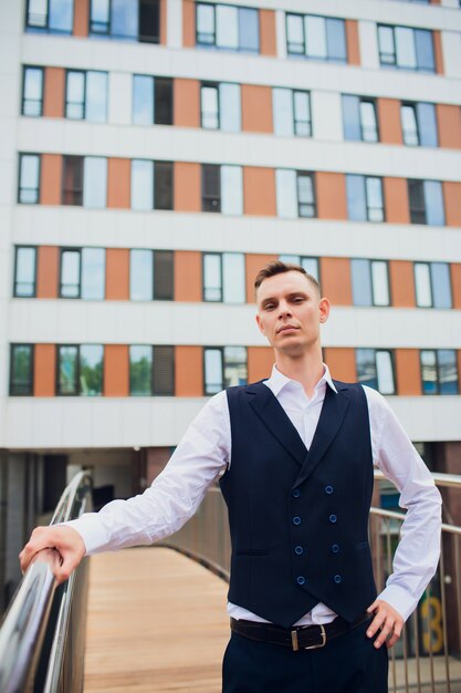 Young businessman on skyscrapers background