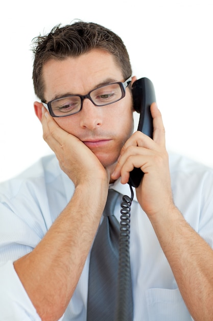 Young businessman sleeping on phone 