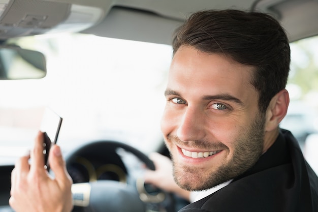 Young businessman smiling at camera